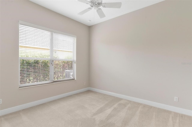 spare room featuring ceiling fan and light carpet