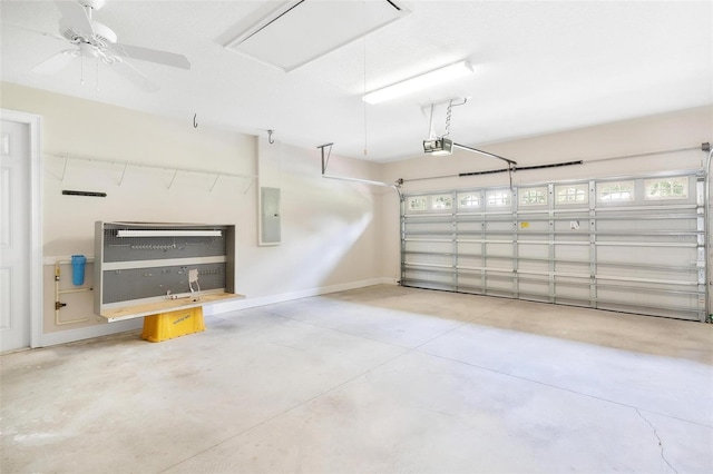 garage with ceiling fan, a garage door opener, and electric panel