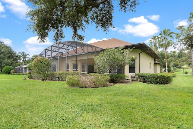 back of house with a yard and a lanai