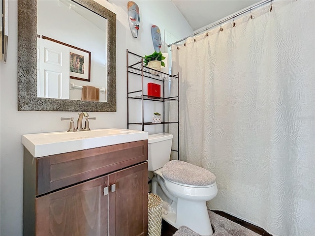 bathroom featuring toilet and vanity