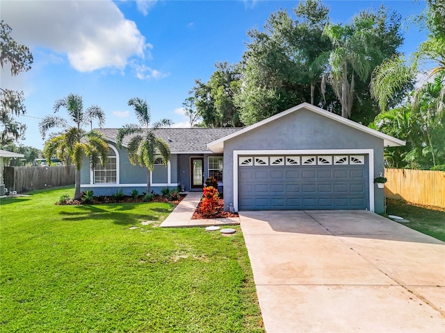 ranch-style house featuring a garage and a front lawn