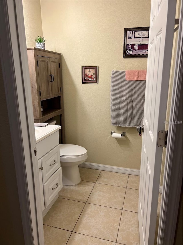 bathroom with tile patterned flooring, vanity, and toilet