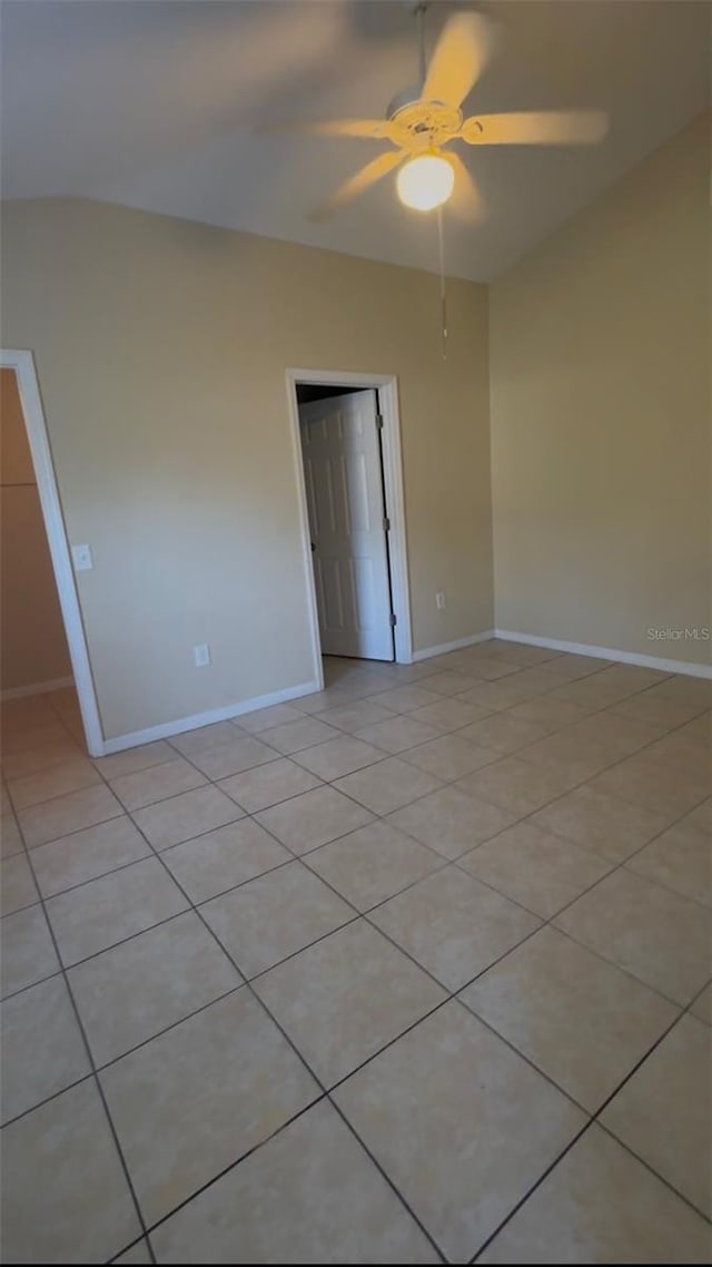 spare room with ceiling fan and light tile patterned flooring