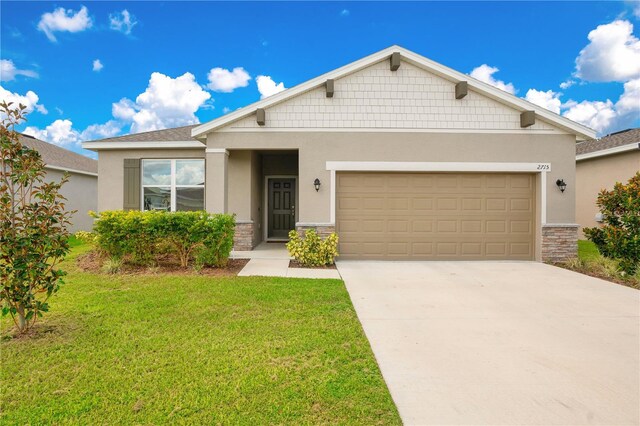 view of front of house with a front yard and a garage