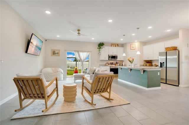 tiled living room with ceiling fan