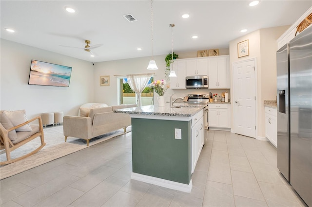 kitchen with pendant lighting, white cabinets, ceiling fan, appliances with stainless steel finishes, and light tile patterned flooring