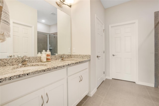 bathroom featuring tile patterned flooring, vanity, and an enclosed shower