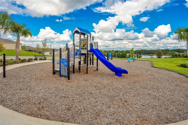 view of playground with a water view and a yard