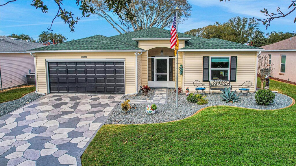 single story home with a front lawn and a garage