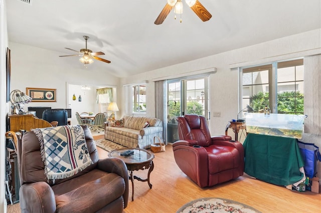 living room with ceiling fan, hardwood / wood-style floors, and vaulted ceiling