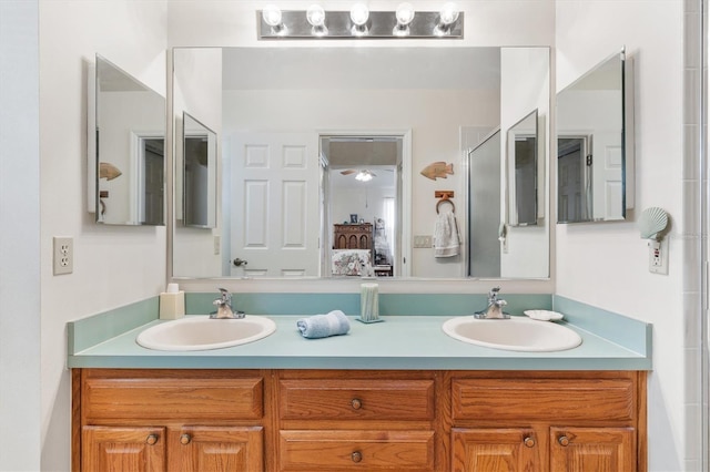 full bathroom with ensuite bathroom, double vanity, and a sink