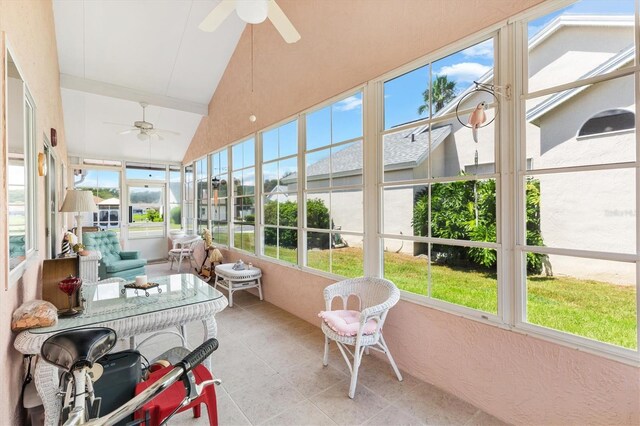 sunroom featuring ceiling fan and vaulted ceiling