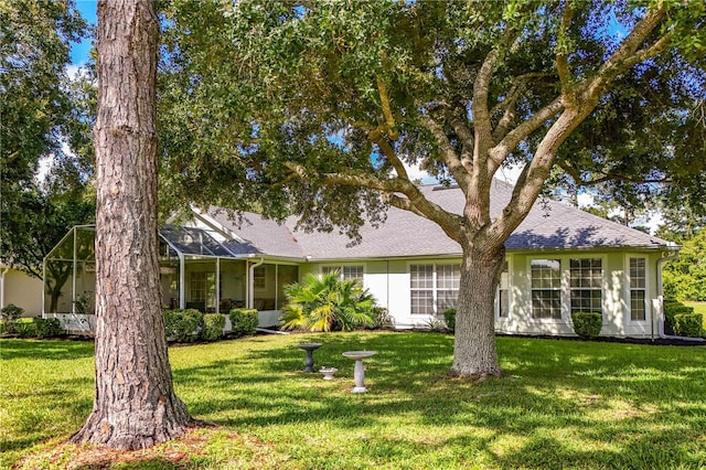 ranch-style house featuring a lanai and a front lawn