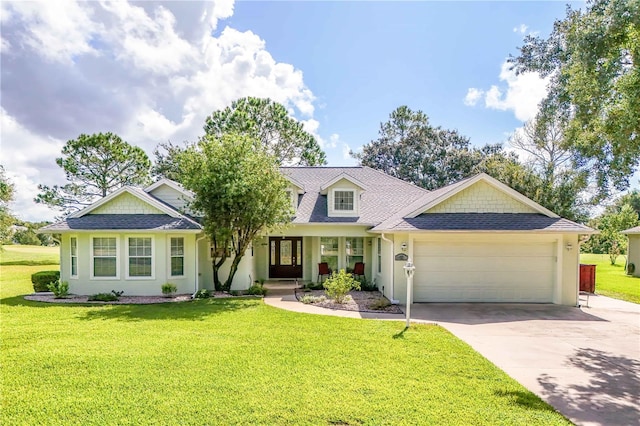 view of front of home featuring a porch, a garage, and a front lawn