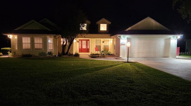 view of front of home featuring a lawn and a garage