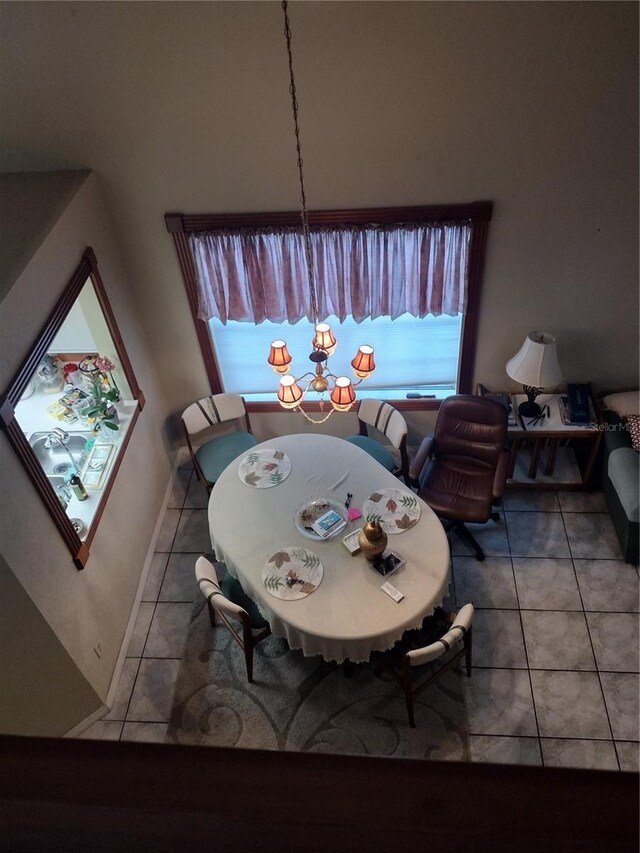 tiled dining space featuring an inviting chandelier