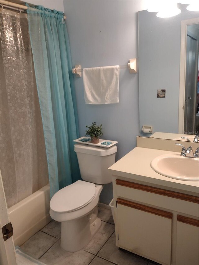 full bathroom with vanity, toilet, tile patterned floors, and shower / tub combo with curtain