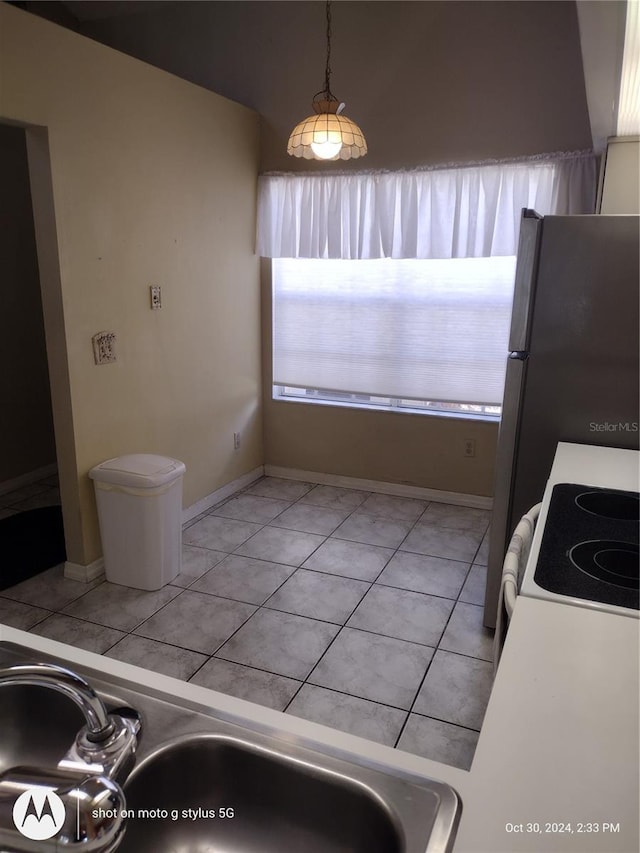 kitchen featuring sink, decorative light fixtures, light tile patterned floors, and white range oven