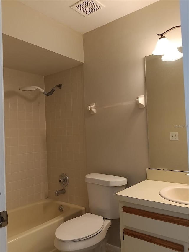 full bathroom with vanity, toilet, and tiled shower / bath