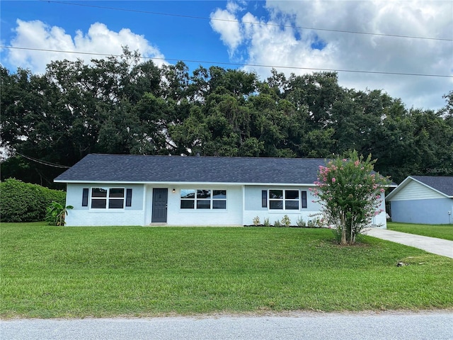 ranch-style home with a front lawn