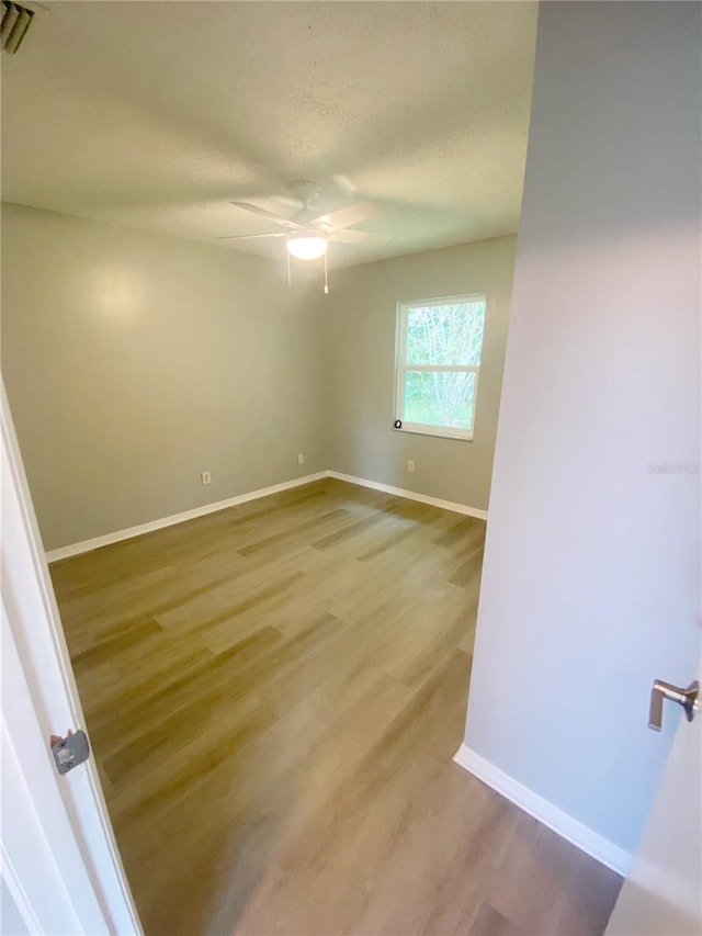 unfurnished room featuring hardwood / wood-style floors and ceiling fan