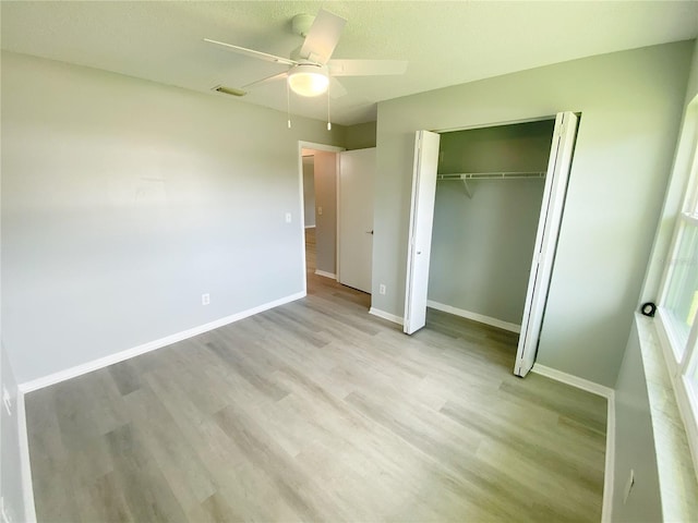 unfurnished bedroom featuring a closet, ceiling fan, and light hardwood / wood-style flooring