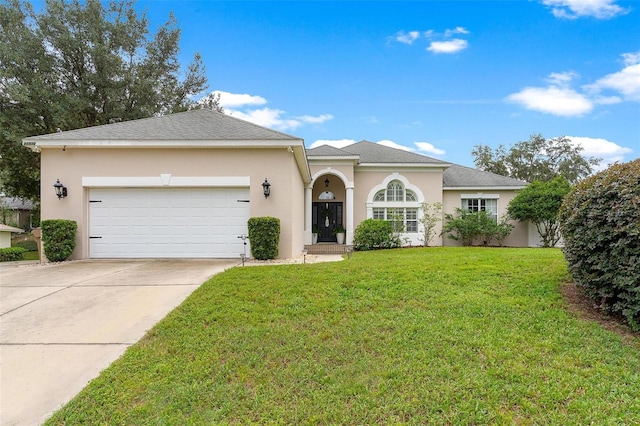 view of front of home with a front yard and a garage