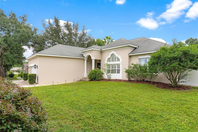 view of front facade with a front yard and a garage