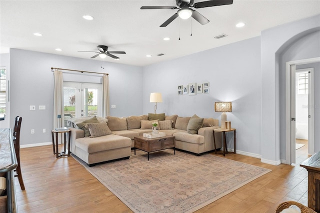 living room with ceiling fan, french doors, and light hardwood / wood-style flooring