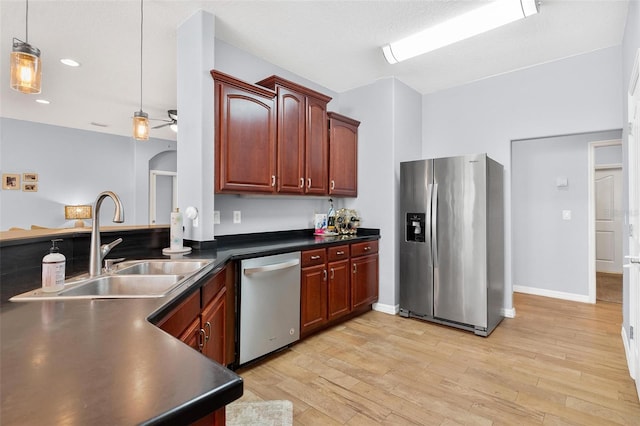 kitchen featuring hanging light fixtures, sink, light hardwood / wood-style flooring, ceiling fan, and appliances with stainless steel finishes