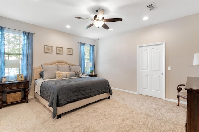 bedroom featuring light colored carpet and ceiling fan