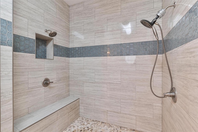 bathroom featuring tiled shower