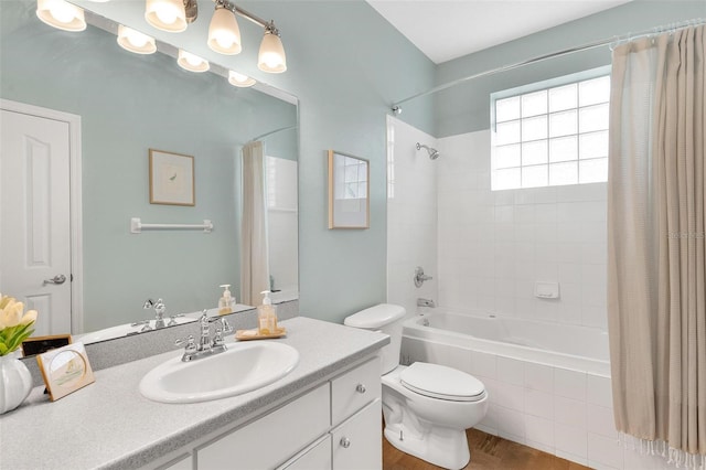 full bathroom featuring vanity, toilet, and shower / bathtub combination with curtain