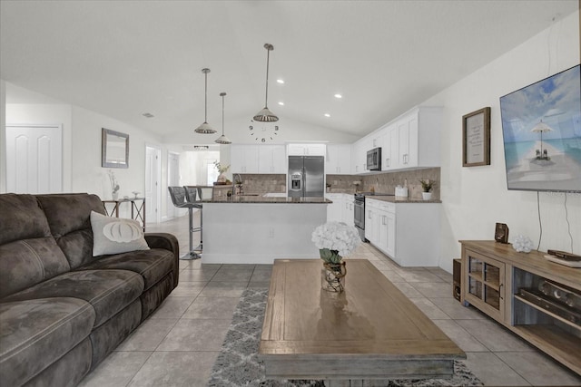 tiled living room with vaulted ceiling