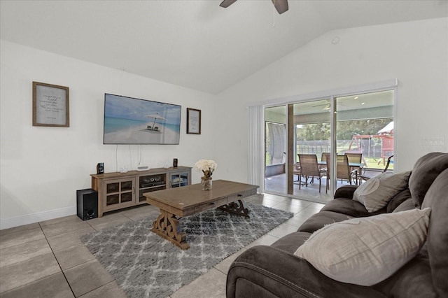 living room with ceiling fan, light tile patterned floors, and vaulted ceiling