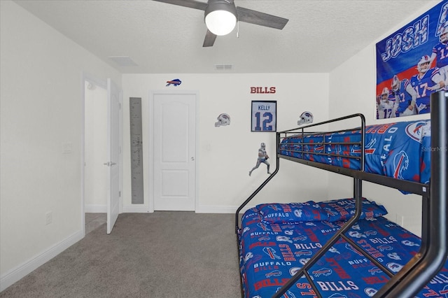 carpeted bedroom featuring a textured ceiling and ceiling fan