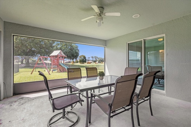 sunroom / solarium with ceiling fan and a healthy amount of sunlight