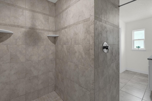 bathroom featuring a tile shower and tile patterned flooring