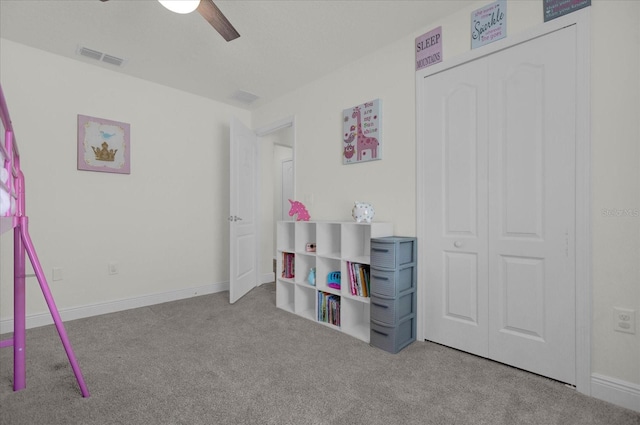 bedroom with ceiling fan, light colored carpet, and a closet