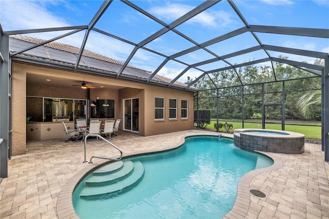 view of pool featuring an in ground hot tub, a patio, ceiling fan, and a lanai