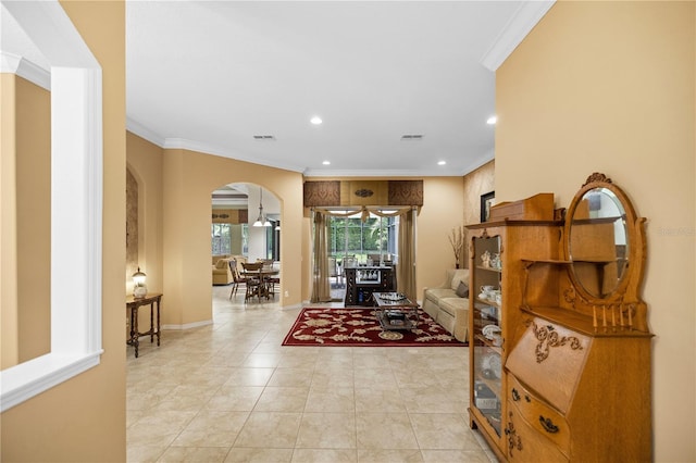 tiled entrance foyer featuring crown molding