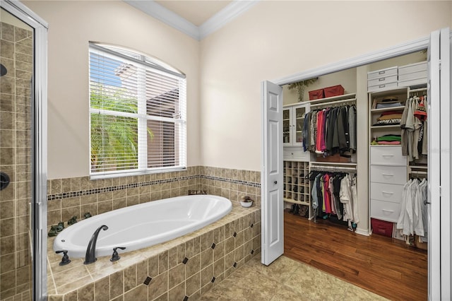 bathroom featuring wood-type flooring, ornamental molding, and plus walk in shower