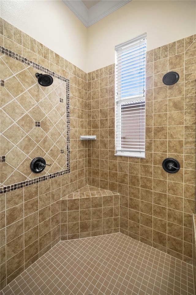 bathroom with a tile shower and crown molding