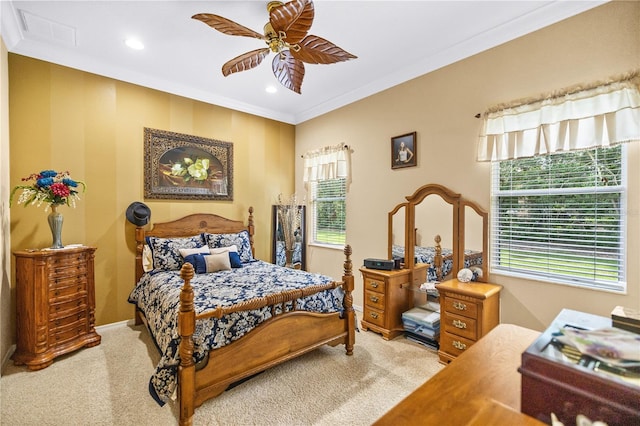 bedroom with ceiling fan, crown molding, and light carpet