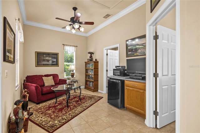 interior space featuring ceiling fan, refrigerator, light tile patterned floors, and ornamental molding