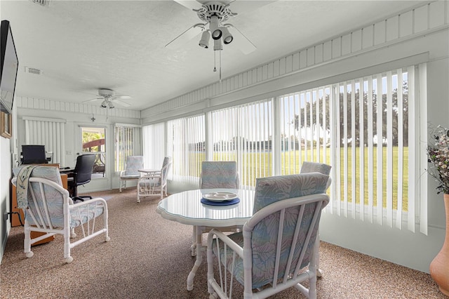 sunroom / solarium featuring ceiling fan