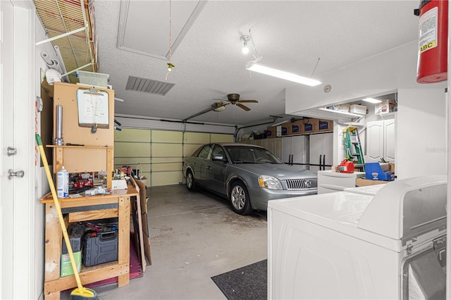 garage featuring independent washer and dryer and ceiling fan