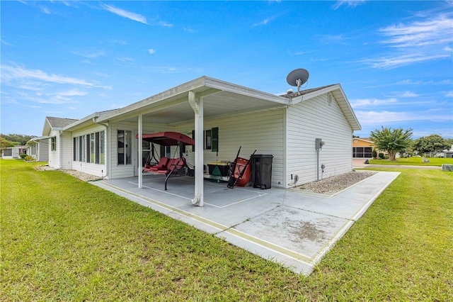 back of property featuring a lawn and a patio area