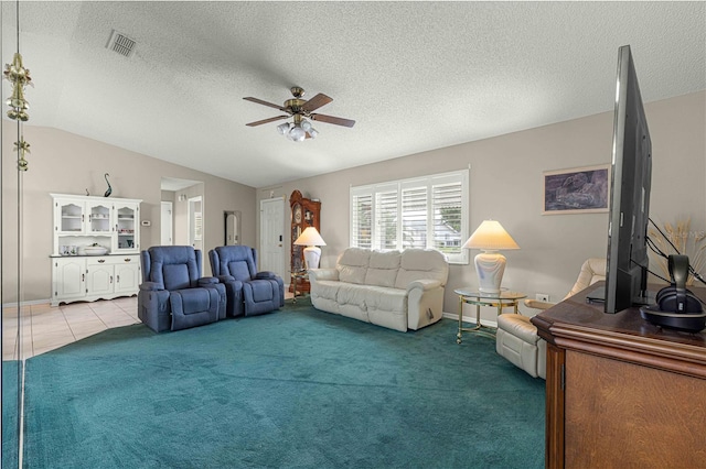 living room featuring a textured ceiling, lofted ceiling, ceiling fan, and carpet flooring