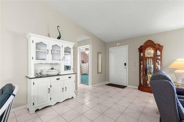 tiled office with a textured ceiling and ceiling fan